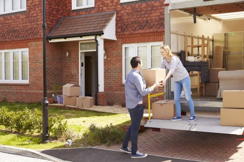 Removal van and moving boxes in a Queens Park residential street