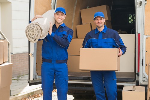 Packed household boxes and moving supplies for a Queens Park home move