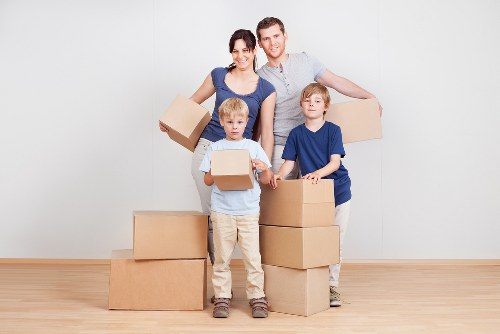 Packed moving boxes and household items prepared for collection in Queens Park