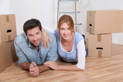 Professional movers carrying furniture near Queens Park homes