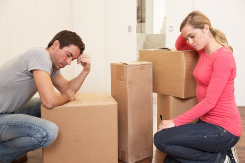 Packed moving boxes and furniture ready for transport in Queens Park