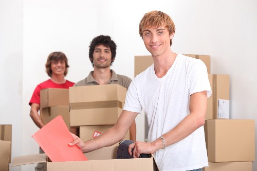 Professional movers handling bulky furniture during a local house removal